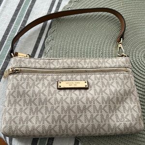 Small Michael Kors cream colored clutch.